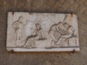 Wall sculpture, including one man stabbing another